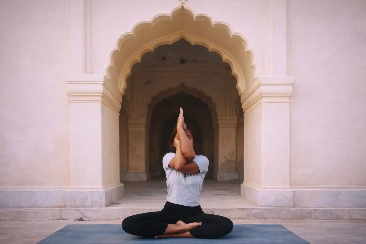 Professional yoga instruction in a serene, traditional setting